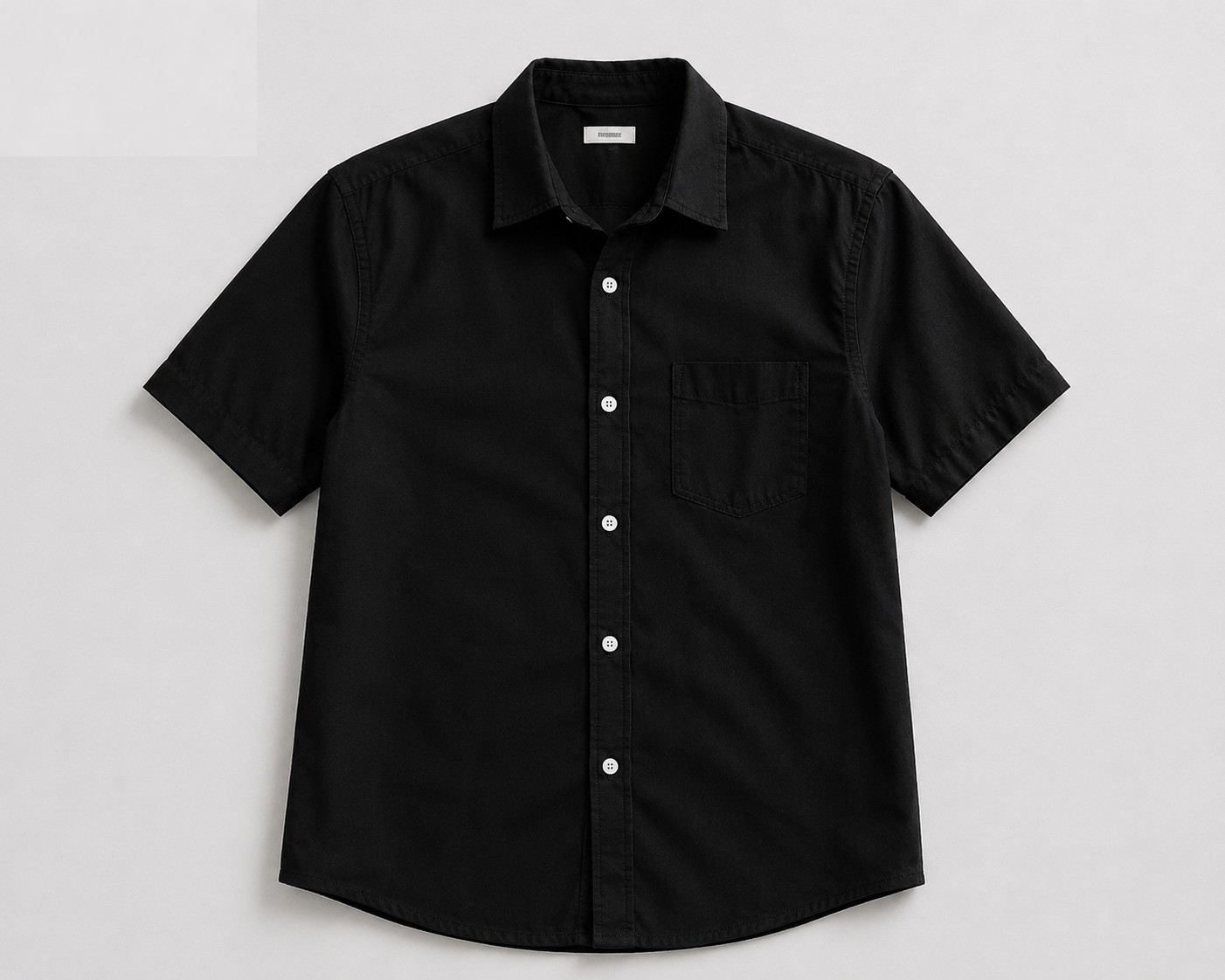 Step 1: upload your garment photo — a black short-sleeve shirt, flat lay